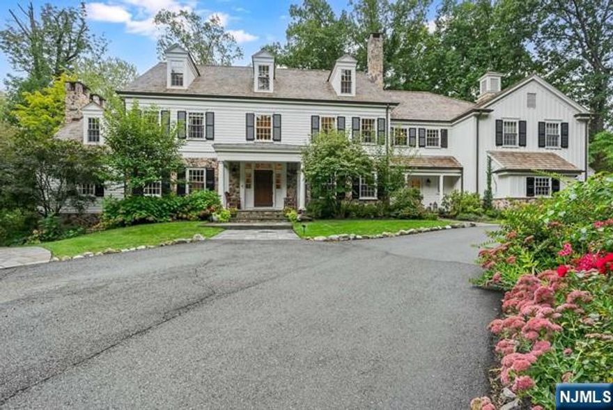 Welcome to 10 Hawthorne Rd, perfectly positioned in the heart of in Essex Fells, NJ- NYC's most luxurious suburb. Located on over 2+acres of private picturesque property, this charming, custom built home offers timeless elegance and designer finishes. Step into a grand two-story foyer as you enter into an over sized eat-in kitchen with open flow to a large family room with a full bar, perfect for entertaining. The first floor also boasts a formal dining room, wet bar and intimate living room, along with a study featuring custom mahogany built ins as well as a mudroom off of the kitchen. The second floor offers a large Primary Suite with a separate sitting room, three massive custom closets,as well as a luxurious bathroom with radiant heat, a jetted tub and steam shower features. The second floor additionally offers four ensuite bedrooms as well as a spacious laundry room. Third level includes an additional bedroom and bathroom as well as plenty of flex space. This home has it all!
