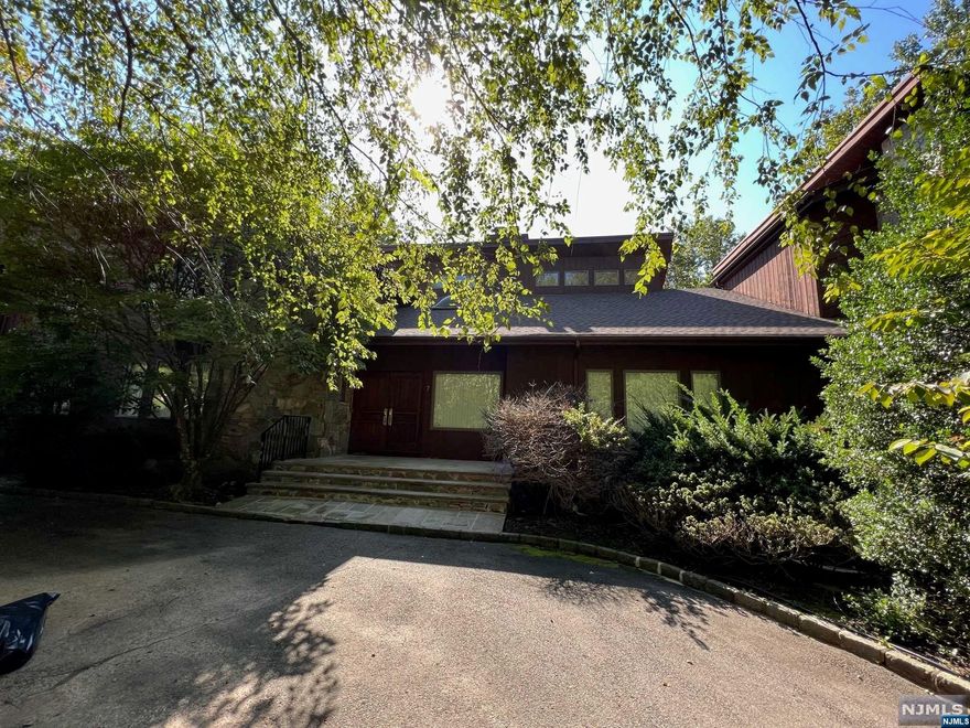 Explore this exquisite 7,000 sq ft cedar stone house in Alpine, offering modern open-concept living. The first floor seamlessly connects dining, living, great rooms, EIK, powder rm, laundry, and a bdrm w/ full bath. Step onto the deck off the great room, perfect for entertaining. Upstairs, discover a primary bdrm suite and 3 more bdrms. One bdrm has an en-suite bath; the other two share a full bath, completing the 2nd floor. High ceilings grace the interior, enhancing space and luxury. A 3-story library and office provide a retreat for reading and relaxation, recently added for your enjoyment. The basement offers a rec area with a bar, gym, office, half bth, and a summer kitchen. Outside, a Pugliese pool awaits on just under an acre, creating a private oasis. With taxes at $19,000, this gem offers luxury and privacy in a tranquil cul-de-sac location. Experience sophistication, tranquility, and the ultimate in upscale living, complete with a circular driveway and 3-car garage.