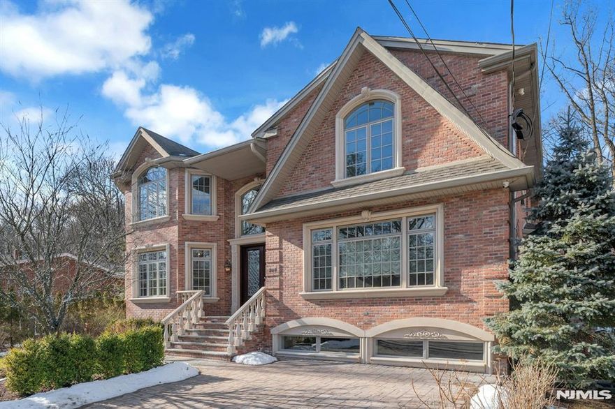 MAGNIFICENT BRICK MANOR HOME WITH AMMENITIES GALORE. LARGE MARBLE ENTRANCE FOYER W/ SWEEPING FLAIRED STAIRCASE SETS THE STAGE FOR THIS EXTRAORDINARY MOVE-IN HOME. ELEGANT LIVING RM, FORMAL DINING RM W/ COFFERED CEILING, FRENCH DOORS TO OFFICE/LIBRARY W/ FPL.MEIK WITH BUTLERS PANTRY AND 2ND DISHWASHER. FAMILY RM W/FPL AND FRENCH DOORS LEADS TO VERANDA AND PATIO OVERLOOKING WOODLANDS FOR TOTAL PRIVACY.PRIMARY BEDROOM IS EXPANSIVE W/SITTING RM, WALK-IN CLOSETS AND SPA-LIKE BATH. 3 ADD'L BEDROOMS WITH EN-SUITE BATHS AND RADIANT FLOORS. FINISHED GROUND LEVEL HAS FAMILY RM, BEDROOM, BATH, ACCESS TO REAR YARD,HEATED GYM WITH EPOXY FLOOR. ADDITIONAL FEATURES INCLUDE GENERATOR, MULTIPLE ZONES FOR HEAT AND A/C AND CLOSE PROXIMITY TO NYC.