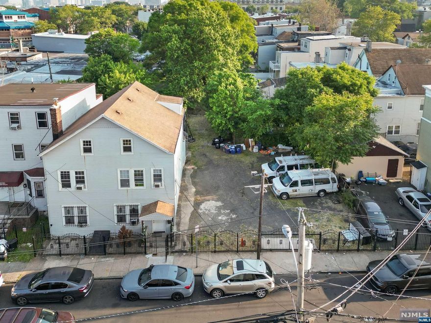 Massive (3) three-family plus 2 lots (separated deeds) INCLUDED in the sale! 16 Nursery (18x100) & 18 Nursery (30x50). Each unit offers 2 bedrooms, kitchen, living room and one bath. Offering many opportunities for owner occupied, INVESTORS or business owners looking for your own parking lot. Property being Sold "As Is".