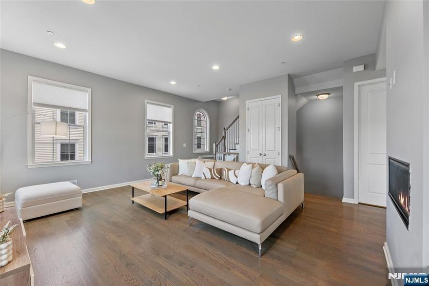 Call Charmy Morzaria 609.619.2198 to tour.Welcome to NORTH EAST Facing,END UNIT,Colonial Style Luxury townhome located in FINEST & sought after Wright Place Community of Wood Ridge;ONLY 3 YEARS OLD & so much to offer including approx.2 years of TAX ABATEMENT!Just 30 mins from Manhattan,close to major turnpike/freeways,offers ease of commute to NYC,Hoboken,Jersey City,Secaucus.Wood Ridge has its own train station at Just 5 MINS WALK from this home & also offers option of 2 buses going into Manhattan that runs every 10-15 mins.This home has(NORTH EAST facing)front & rear entrance w/2car garage,2 car driveway(EV Charger Outlet equipped).1st floor has 9ft high ceilings,tall windows,2 closets,open Flex space can be used as entertainment space/office space or can be easily converted to bedroom#4,this level also has half bath.2nd floor boasts 10ft high ceilings,tall windows,massive dining space,modern Kitchen w/breakfast bar,SS appliances,Quartz countertops,large living room w/outdoor deck. Open concept perfect for entertaining.3rd floor has primary bedroom w/full bath, his&her closets,2 add'l bedrooms,full bath & laundry room;2 Zone heating/cooling,hardwood floors throughout.Wood-Ridge has so much to offer;good schools,restaurants,Cafes,liquor shop,pet grooming,phenix salon,sports field,parks,just steps away from Catherine Doyle school,on-site train station and buses close by for for easy NYC commute.Perfect home for buyers+a great investment option with high rent potential.