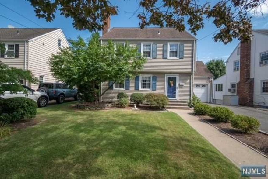 Lovely Side-Hall Colonial situated on a quiet, tree-lined, cul-de-sac street in the highly-desired Spring Garden Section. Just blocks away from the elementary school and up the block from the NYC bus stop. This home is in move-in condition with central AC and all original hardwood flooring throughout. The first floor is perfect for entertaining with all the rooms flowing into one another, consisting of a formal dining room with sliders that lead to an expansive deck overlooking beautiful trees that create a peaceful and private space, a living room with a gas fireplace, a half bath, and a renovated kitchen with quartz countertops, white subway tiling, a double-oven, and large breakfast bar. All three bedrooms are generously sized and are located on the second floor with lots of storage including a 6x10 walk-in closet in one of the bedrooms. The walk-out finished basement is spacious with lots of storage leading out to the fully fenced-in yard and above-ground pool with a heater.