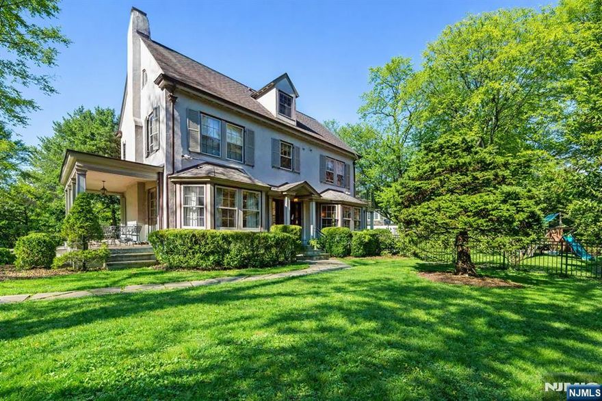 Charming Arts & Craftsâ€“inspired Center Hall Colonial featuring 5 bedrooms and 3.5 baths on beautifully landscaped property with a large fenced backyard. The first floor offers a gracious foyer, formal dining room, living room with working fireplace, and a sunlit, fully renovated kitchen with top-of-the-line appliancesâ€”perfect for entertaining. The second floor includes a primary suite with a full bath and two large walk-in closets, an additional bedroom and a full bath, plus an office and laundry. The third floor features three bedrooms, a full bath, and ample storage. Built-ins on the first and third floors add character throughout. Enjoy lovely front and rear porches, a Belgian block driveway, and a detached two-car garage with an artist studio above. Conveniently located near shops, restaurants, transportation, and houses of worship in Englewood, New Jersey.
