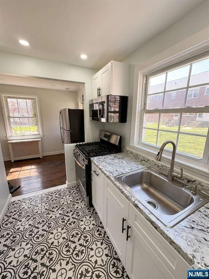 A beautifully updated first-floor condo in the highly sought-after Maplewood Village community. Conveniently located near downtown Maplewood, offering shops, restaurants, parks, and direct NYC commuter trains. The Maplewood Community Pool is just minutes away. The home has been fully refreshed with modern finishes throughout. Brand new kitchen featuring crisp white cabinetry, a full suite of new GE Appliances, and clean, contemporary design. Completely renovated bathroom with stylish gray vanity, sleek black fixtures, soaking tub with rainfall showerhead, and all-new tile, walls, ceiling, and lighting. Additional highlights include a spacious bedroom with ample closet space, new air conditioning units, efficient heating, private entrance with covered porch, and one deeded parking space.