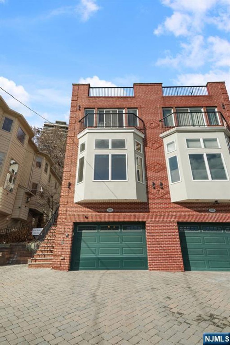 Nestled in Edgewater's highly sought-after south side, this exceptional townhouse offers breathtaking, unobstructed views of the iconic New York City skyline. The spacious 3 Br 3.5 Ba home offers an open concept on the main level with living and dining areas, a cozy fireplace, a designer kitchen, and backyard access. Third floor opens to the primary bedroom with a balcony, ensuite bathroom, and spacious walk-in closet. Two more bedrooms, a second full bathroom, and a washer, and dryer on this floor. The top floor private, rooftop deck provides sweeping views of the NYC skyline and the Hudson River, an ideal retreat for relaxation or hosting guests.The lower level includes a versatile family room, a guest room, and a full bath with 1 car garage and paver driveway. Enjoy easy access to shopping, and parks, and an effortless commute to NYC via bus and ferry Tenant responsible for backyard maintenance of $600/year