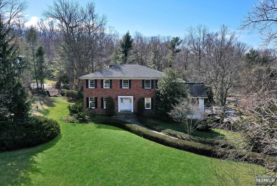 Perched in a prime location on one of Alpine's coveted cul de sacs, this timeless Georgian Colonial boasts over 4,200 sq.ft. of spacious living. Approx. one acre picturesque property and private lush landscaped grounds. Custom built and designed by the original owner in 1973. First time offered! Rare and sought after opportunity to renovate the existing home or build new on this spectacular property and location. Add your creative personal finishes and make it your own. Updated gourmet kitchen offers a generous center island and open flow to a sun filled great room. Family room and library/office both feature gas fireplaces. First floor private guest suite. Four spacious second floor bedrooms including huge Primary Suite. Grade level multi purpose basement with a 3 car garage. Prestigious Alpine is regarded for its excellent award winning schools, close proximity to NYC (8 miles to GWB), low real estate taxes and extraordinary community offering privacy and tranquility.