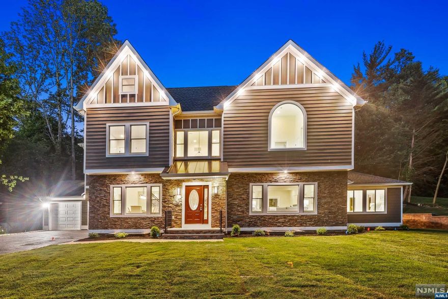 Designed by a famed local architect, this spectacular colonial combines open concept, modern, convenience and luxury into a dream home. More than 6120 SQFT living space consists of 4 finished levels with high ceilings, 5 suites, offices & bonus rooms. Oversized windows throughout the house bring abundant natural light. The Inviting two-story foyer opens to dining rm & living rm. The gourmet kitchen boasts a 10'x6' giant waterfall island, custom wood cabinets, top end appliances, dual sinks, large brkfast room. The spacious in-law suite with separate entrance completes the 1st floor. Second floor boasts a large master suite w/two WICs, spa-like bath w/jetted tub&stall shower, and a large private balcony. Three other suites and laundry room complete the 2nd floor. The finished 3rd floor is a giant playroom. The 9' ceiling basement is great for entertainment, W/a full bath & an office/maid quarter. Conveniently located with walk to schools, Short Hills Mall, NYC direct train &parks.