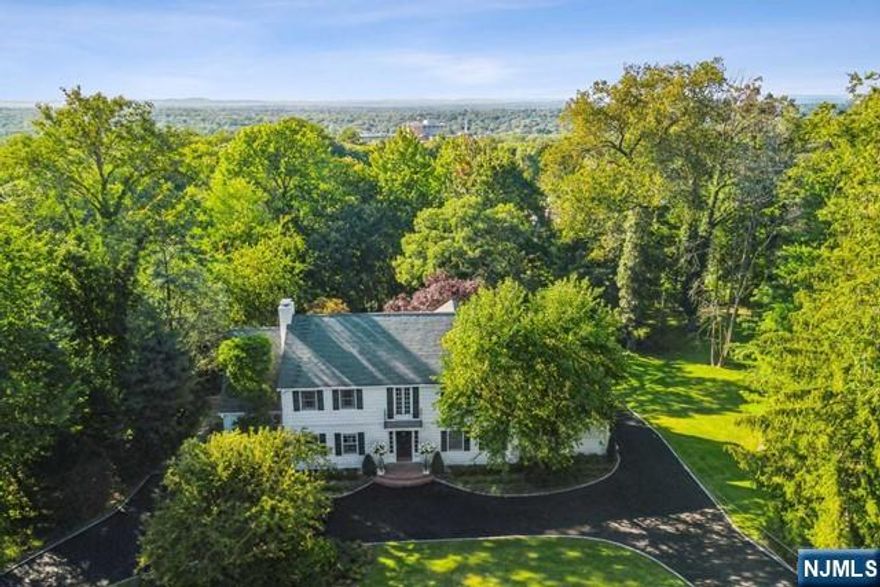 This majestic colonial residence is set on approximately 0.70 acres of lushly landscaped property on one of the most desirable streets on the East Hill. It offers spacious rooms throughout and features two home offices, providing the flexibility of a 6th bedroom with an adjacent full bathroom on the first floor. Ideal for luxurious living and entertaining both indoors and outdoors. Inside, classic elegance abounds with gorgeous hardwood flooring throughout, millwork, two fireplaces, a Juliet balcony, two staircases, and many other exquisite details. Lower level hosts a bedroom with a full bath and a walk-out, adding to the home's versatility. Outside, the home boasts a brand-new driveway and a magnificent new two-level deck, with a staircase leading to an expansive yard, offering room for a pool. Located near houses of worship, downtown shopping and restaurants, major highways and bus routes to NYC, this home epitomizes timeless elegance.