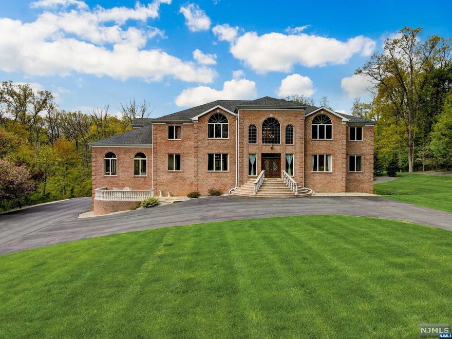 This NE facing home in a sought-after community boasts sophistication. Its fully brick exterior welcomes you with granite steps & balustrade rise. Inside, the harmonious flow blends spaces for entertaining & everyday living. The 900+ sqft gourmet kitchen features top-of-the-line appliances, custom Brazilian wood cabinetry, & a spacious U-shaped center island. The main floor offers an en-suite bedroom, laundry room, & powder room. The top-level primary suite is a private sanctuary with 2 dressing rooms & a luxurious en-suite bathroom. The remaining 4 bedrooms are en-suites, each unique in size and style. The newly finished lower level offers 3,000+ sq ft of marble-tiled space with a kitchenette, office, & full bath. Enjoy outdoor dining on the large granite deck while admiring picturesque vistas. This property epitomizes opulent living & leaves a lasting impression on all who enter.