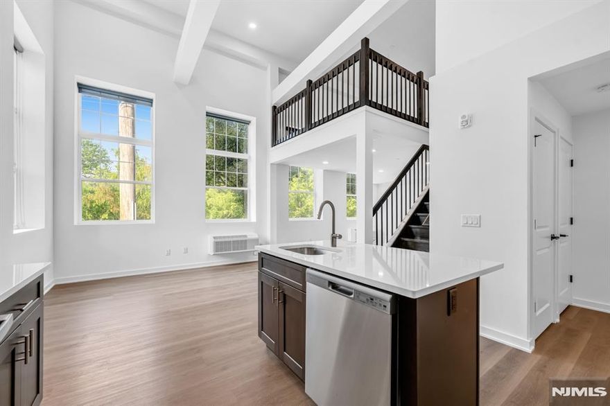 Discover pure luxury in this stunning, new construction 1 Bedroom Loft / 2 Bathroom apartment conveniently located in highly sought after East Rutherford. Stretching across 1,024 SqFt, this brand new unit features lofted ceilings, gleaming wood floors, in unit washer/dryer, multi-zone heating and cooling, and plenty of sunlight throughout the day. First floor includes entry foyer, kitchen, living room, dining room, full bathroom, and laundry. Chef's kitchen features SS appliances, custom cabinets, quartz countertops, and breakfast bar. Completing this beautiful home is a second floor with bedroom, ensuite bathroom, and walk-in closet. 315 Railroad is a one-of-a-kind building featuring virtual doorman, resident patio, dog run, and ample parking. Conveniently located just steps from downtown East Rutherford & Rutherford, NJ Transit train station and bus stop, restaurants, shopping, parks, and schools. This rare opportunity is one you don't want to miss!
