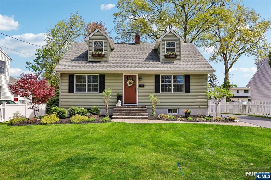 Beautifully maintained 4-bedroom, 2-bath Colonial Cape set on a picturesque tree-lined street in one of Ridgewoodâ€™s most desirable neighborhoods. Offering timeless curb appeal and thoughtful updates throughout, this inviting home blends comfort, style, and convenience. Step inside to a welcoming living room that flows seamlessly into the dining area and updated kitchen featuring abundant storage and lovely views of the manicured backyard. Sliding door access to the rear deck creates the perfect setting for indoor-outdoor living, entertaining, or relaxing. The first floor offers a spacious primary bedroom, an additional bedroom, and a full bath, providing flexible one-level living options. Upstairs features two generously sized bedrooms and a full hall bath. A partially finished basement adds valuable bonus space ideal for a media room, family room, home office, gym, or recreation area. The fully fenced backyard is a private retreat complete with deck, hot tub, paver patio, and storage shedâ€”designed for year-round enjoyment. Ideally located near Hawes Elementary School, NYC transportation, parks, and vibrant downtown Ridgewood shopping and dining. A rare opportunity to enjoy exceptional location, lifestyle, and lasting value.