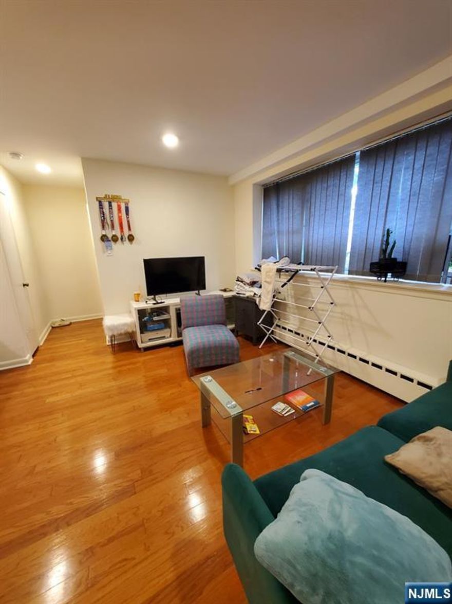 The best location in Fort Lee. This is an extra-large studio. Located on the ground floor ( not the basement), it comfortably accommodates a queen-size bed, a Table, chairs, and a Sofa. Water, Hot water, Heat, Tax, Trash disposal, and one(1) outdoor parking space #13 are all included in the rent. The unit has tons of storage space, including the large front closet, the extra-large walking closet with a drawer, and the linen closet near the bathroom. Walking distance to the Downtown Fort Lee commercial district, school, restaurant, and cafe. Walking distance to the Bus stop to NYC.