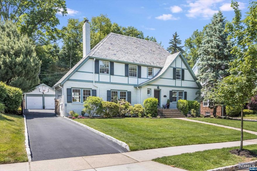 Welcome to this gracious, light-filled Tudor, located in the sought-after Fairway section of Montclair! Nestled between Yantacaw and Brookdale parks, just one block to NYC transportation and four blocks to the shops and restaurants of Upper Montclair Village, everything you need is within reach.The open 1st floor includes a family room leading into the brand new Chef's kitchen with gorgeous modern fixtures.The 2nd floor features a spacious Primary with ensuite bath and two walk-in, cedar closets. Two additional BR's and another full bath complete this level. The 3rd floor includes another spacious BR and full bath, plus bonus room to be used as a 5th bedroom or flex space.The finished lower level offers additional room for playroom or work out area and has an updated powder room. Outside, the freshly painted exterior, new fencing, recently paved driveway and lush landscaping are the perfect setting for summer entertaining. Central air, electric car charger, and so much more.