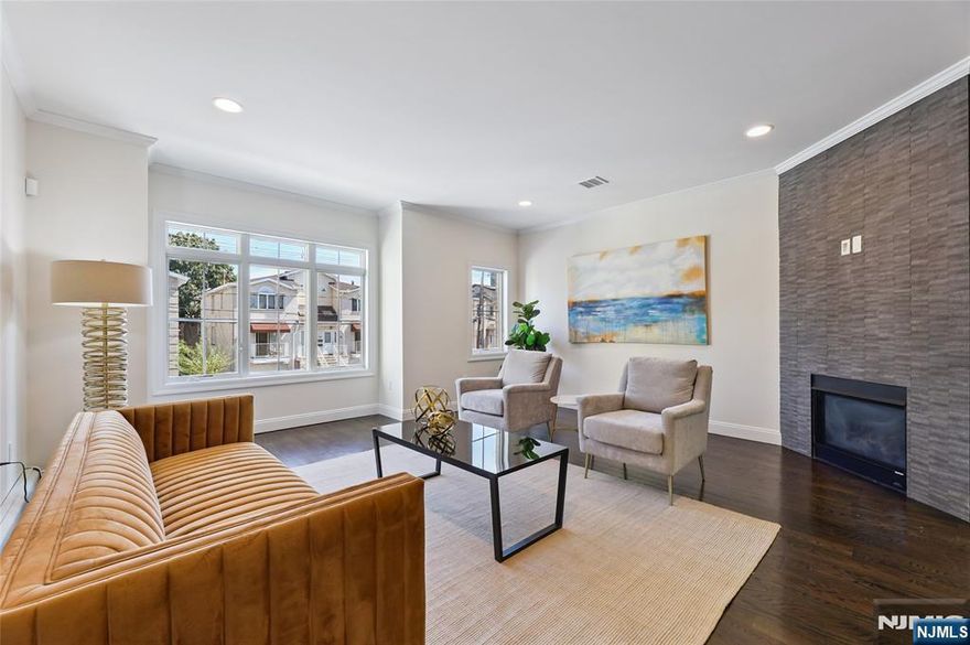 Welcome to 284 Knox, where the moment you walk through the door, you'll feel right at home in this charming Cliffside Park townhouse. The kitchen is truly the heart of this space - it's where real life happens, from helping with homework while cooking dinner to sharing laughs with friends around the oversized island. The deck is a griller's dream with its built-in gas line - no more lugging propane tanks up and down stairs! Head upstairs to find your peaceful primary suite with generous closet space, plus two more bedrooms, a full bath, and the convenience of second-floor laundry (because who wants to carry baskets up and down?). The lower level features a cozy family room that opens to your own backyard sanctuary. Whether you're dreaming of a veggie garden, need a safe space for kids to play, or want a private spot for your pup to roam, this outdoor space delivers. Inside, gorgeous hardwood floors flow throughout, while practical features like the garage (EV-charger ready) and central vac make everyday living easier. Location? It couldn't be better. Your morning coffee run, local shopping, school drop-offs, and the NYC bus are all just a short walk away. This isn't just another house on the market - it's a place where memories are waiting to be made. Come see what makes this special place feel like home. Welcome Home!