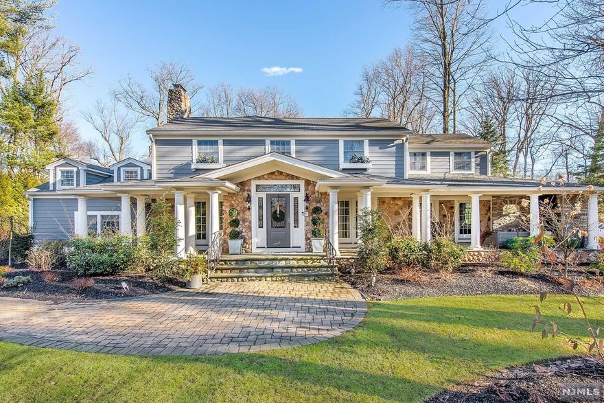 Exceptional Essex Fells Colonial offers the ultimate lifestyle and exclusivity. Extraordinary architecture with jaw-dropping modern industrial interior design. Design-savvy enthusiasts will be in awe of this exquisitely designed property incorporating the perfect blend of farm house coupled with raw elements, dramatic lighting and sleek metals. Desirable floor plan created to meet the needs of today's lifestyle, seamlessly incorporating private spaces along with areas to come together for enjoyment. First floor has a custom mudroom, high-end kitchen, family room, living room, industrial bar room and office. Office offers a library, cozy stately fireplace and access to the wrap around porch. Chef's Kitchen is a showstopper with massive island, custom cabinets, limestone countertops, top of the line appliances and stone fireplace. The second level encompasses five bedrooms, including a well appointed, exquisite master bedroom suite. Sprawling backyard with a patio and yard space.