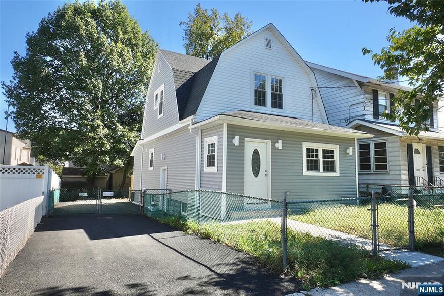 Welcome to this beautifully renovated Colonial featuring an open-concept design. Offering 2,000 sq. ft. of living space, this home includes a spacious living room, dining room, modern kitchen, four bedrooms, and three newly renovated bathrooms perfectly designed for today's flexible lifestyle. Step inside to a warm entryway with an enclosed porch and coat closet, leading into a bright, airy living room filled with natural light from large windows. The adjoining kitchen and dining area create the ideal setting for everyday living and entertaining. Upstairs, the private primary suite boasts a stylish ensuite bath and generous closet space. The fully finished lower level expands the home's versatility with a laundry room, abundant storage, and a separate entrance to an additional recreational area. Conveniently located close to transportation to NYC, parks, and schools.