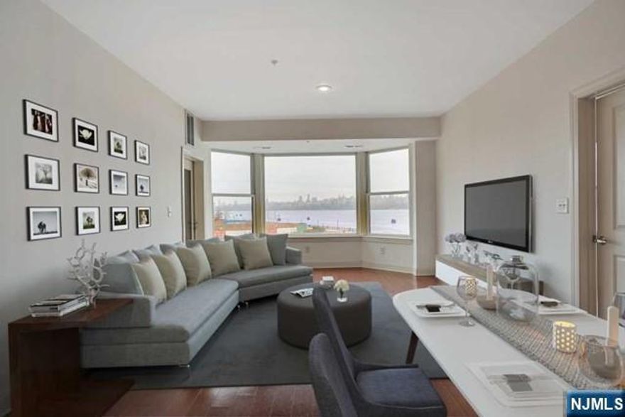 **TAX APPEALED FILED - 13K TAX EXPECTED** Welcome to this stunning Northeast-facing 2BR/2BA residence at the prestigious Grandview II, a premier waterfront community directly across from Manhattan along the Hudson River. Spanning 1,293 sq. ft., this beautifully designed home offers a bright, open-concept layout with breathtaking panoramic views of the NYC skyline and river. The chef-inspired kitchen features SS appliances, granite countertops, & a center island that seamlessly connects to the dining and living areas perfect for both everyday living and entertaining. The living room is framed by oversized windows and opens to a private balcony, where you can unwind while taking in the spectacular waterfront scenery. The expansive primary suite serves as a private retreat, complete with a large walk-in closet and a spa-like ensuite bath featuring dual vanities, a Jacuzzi soaking tub, & a separate glass-enclosed shower. The generously sized second bedroom and full bath are thoughtfully positioned on the opposite side of the home, offering ideal privacy for guests or a home office. Enjoy resort-style amenities including a 24-hour doorman, outdoor swimming pool, state-of-the-art fitness center, business center, resident lounge, and childrenâ€™s playroom. Commuting to NYC is seamless with Ferry, Light Rail, and bus service just steps from your door. With dining, shopping, and a grocery store conveniently located downstairs, this home offers a blend of luxury & lifestyle convenience
