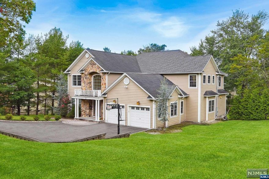 Prime Riker Hill Section custom colonial built in 2011 ( original 1968 foundation remains, which was expanded in 2011 when new home built ). Beautiful open concept home, featuring 5732 sq ft of finished living area, fully finished walk-out lower level with bedroom #6 and full bath, office, exercise room and large Family Room. The 1st floor features spectacular 2 story entry, library/den, large kitchen opening onto Great Room and formal dining room, powder room, 5th en-suite bedroom w/full bath, powder room, mudroom and direct access to garage and sliders to rear deck. The second level features 4 large bedrooms and 3 full baths, laundry room. This home is ideally located on .56 lush property and is located in the Livingston Blue Ribbon School District.