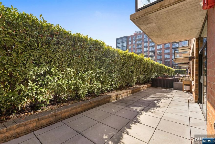 Incredible two bed, two bath home with attached private patio in the luxury community of 1100 Maxwell Ln! Open floorplan and East-facing floor-to-ceiling windows mean the home is soaked in sun. Chef's kitchen features quartz countertops, stainless steel appliances and custom cabinets. Primary bedroom features a walk-in closet and luxurious ensuite bath. The spacious secondary bedroom with its own walk-in closet and the additional bathroom round out this perfect home. Also included is central A/C, in-unit washer/dryer, gleaming hardwood floors, and deeded parking spot #40. The communityâ€™s generous amenities include 24/7 concierge and security, 2 gyms, 2 pools, 2 playrooms, 2 rooftop decks with BBQ grills, community rooms, and shuttle service to and from the Path. The building is conveniently located near the NYC Ferry, bus stop, shops, restaurants, and everything that uptown Hoboken has to offer.