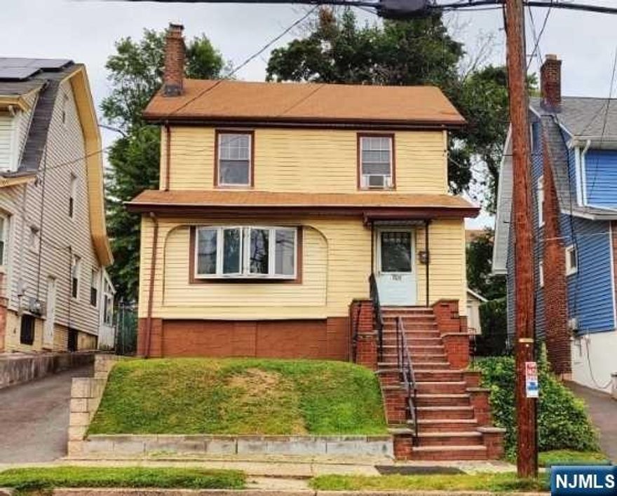 Situated on an elevated lot, this property has a lot of potential. After entering a large enclosed porch, you are welcomed with high ceilings and exposed beams in the living room with fireplace/stove which gives way to a formal dining room, large kitchen, and full bath to round out the first floor. You'll notice the classic moldings and trims throughout making way to the upstairs where you'll find a landing playing host to 3 large bedrooms, full bath, and partially finished walk-up attic with enough headroom to create additional living space. The basement is partially finished with enough space to create a rec room for entertaining. Price reflects estimated repair costs. As-is, seller will not make any repairs. Buyer responsible for obtaining C/O.