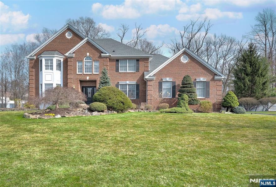 Nestled on a cul de sac, this stately and beautifully maintained colonial perched on meticulously manicured grounds is not to be missed. The dramatic 2 story entry (gorgeous walls are painted not wallpaper) welcomes you into this 5 bedroom, 3 full bath home perfect for entertaining. Brand new hardwood floors on first floor (Feb 2026), eat in kitchen with island and granite countertops, formal dining room, living room, and family room with fireplace. A bedroom/den, full bath and laundry room completes the first floor. Primary bedroom with high ceiling, updated bath (3 yrs) and walk in closet with door to additional storage. Large finished basement spans width of the house and offers plenty of storage. . **BRAND NEW ROOF AND GUTTERS just installed on 3/29/2026 with lifetime guarantee. This beauty is located close to school, parks, shopping, town pool.