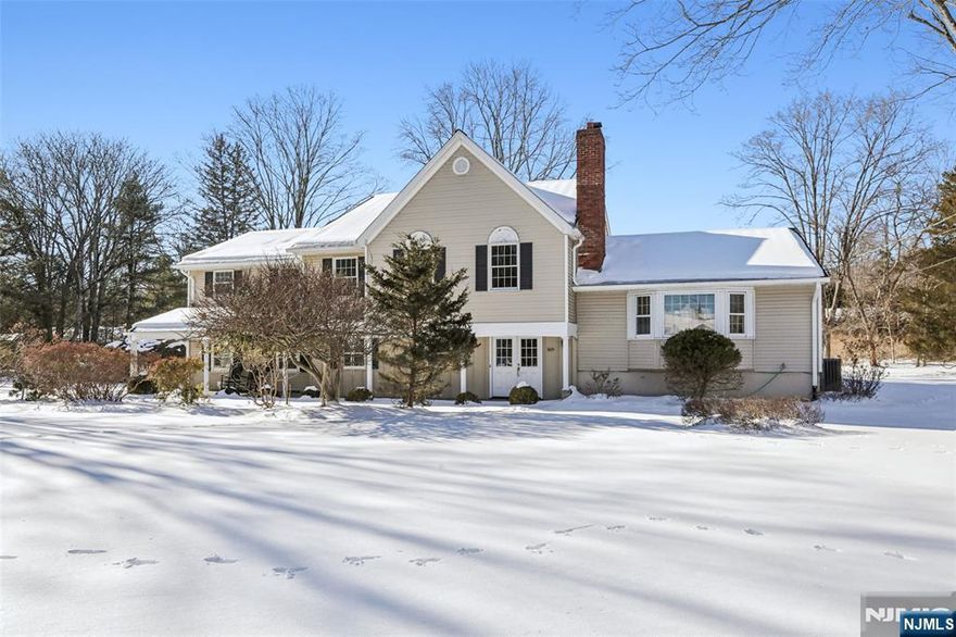 This open and spacious expanded colonial split-level home with a welcoming front porch on almost an acre in sought after Upper Saddle River, offers 5 generously sized bedrooms (two ensuite) and three and a half baths. It delivers exceptional space, flexibility, and comfort for today's lifestyle. Hardwood floors throughout enhance it's warmth and elegance. At the heart of the home is an open-concept kitchen and great room, highlighted by a gas fireplace and skylights, creating a bright and inviting space ideal for entertaining and everyday living. This flows seamlessly into an all-season sunroom, opening to a beautiful slate terrace overlooking the large level backyard and reconnecting to the great roomâ€”perfect for indoor-outdoor gatherings. A grade-level family room with French doors provides additional living space and easy access to outside. A lovely home office with its own entrance offers an ideal setup for remote work, professional use, or guest accommodations. The full basement with kitchenette presents limitless potential for a recreation room, in-law suite, gym, or media space. The elementary and middle schools are next door, and the high school bus stop is conveniently located in front of the homeâ€”an exceptional benefit for families. In addition, the oversized driveway is ideal for guests, bicycles, and basketball! Combining space, functionality, and a prime location, this home offers a rare opportunity to enjoy refined living in Upper Saddle River. Donâ€™t miss!