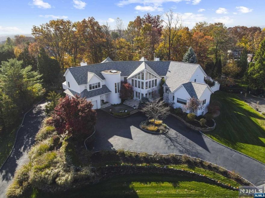 Stunning contemporary 5BR/6.5BA home on one of WCL's most desirable streets close to NYC! 2-story entry w/soaring ceilings, striking architecture & natural light floods the spacious living spaces. Great Room w/35ft ceiling, walls of windows, FP & Bar flows seamlessly into DR & Kitchen. Chef's Delight has Gourmet Appliances, Pantry & Sunny Breakfast Rm. Cozy FamRm opens up to Screened In Porch for easy Indoor/Outdoor Access. Pool Cabana w/ 2nd KIT, Changing Rm & FBA leads to Pool/Backyard. 1st FL is completed by a Home Theater & Ensuite BR. 2ND FL features luxurious PBR Suite w/ FPLC, Pvt Terrace, Spa-Like BA & 2 Lg WICs; BR/Off Ensuite; BR 3&4 w/J&J BA & 2nd Laundry. Lower Level houses Rec Rm, Playroom, Bonus RM, FBA & Garage for 6 cars. Elevator & 2 Staircases access all 3 FLs. Relax in Backyard Oasis enjoying Pool/Spa, oversized Deck/Patio & Yard. Hardwood floors throughout, Whole House Generator, NEW Roof 2021; A/C, Heating, Pool Heat/Pump - ALL Updated.