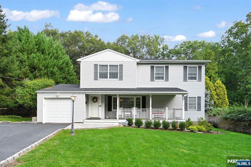 Spacious 2900 sf Colonial on 190' deep private property on quiet residential neighborhood. Inviting front porch leads to entry foyer, living room and oversized dining room. Large skylit country kitchen with center island and eating area opens to great room with woodburning fireplace, perfect for entertaining. There is a first floor primary bedroom with private bath, 2nd bath and laundry. Upstairs you will find a king size bedroom, 2 queen size bedrooms, an office and main bath. The finished basement offers additional living space with rec room, playroom/den and office. Enjoy your heated, gunite pool in the privacy of your deep treed property. Conveniently located to top schools, parks, shopping and transportation.