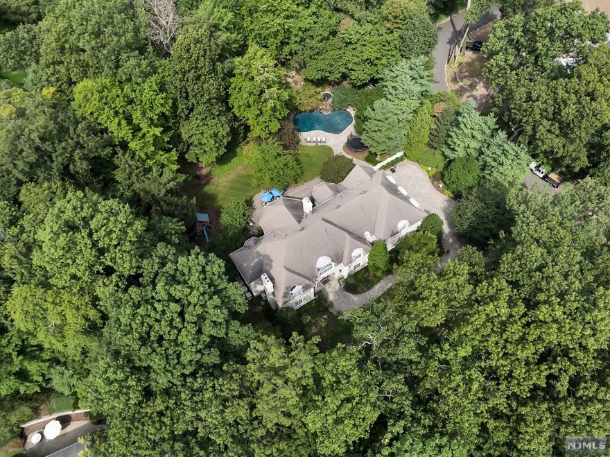 PREMIERE NEIGHBORHOOD IN RIDGE SCHOOL AREA. BLOCKS TO NYC TRANSPORTATION AND TOWN. APPROX. 8000 SQFT, 1.5 PRIVATE ACRES. GUNITE SALT WATER POOL/SPA. SPECTACULAR NEWER KITCHEN LOADED WITH TOP OF LINE APPLIANCES AND DESIGNER FINISHES. GENEROUS LIVING SPACES AND ALL ENSUITE BEDROOMS WITH OUTFITTED CLOSETS AND 6TH BEDROOM ON FIRST FLOOR. BRIGHT & SOPHISTICATED HOME WITH DETAILED MILLWORK, SOARING CEILINGS & GLEAMING HARDWOOD FLOORS. UPDATED INTEGRATED HOME AUTOMATION SYSTEM. IMPRESSIVE FINISHED BASEMENT. 3 CAR ATTACHED GARAGE. AN UNSURPASSED QUALITY BUILD IN ONE OF THE MOST DESIRED NEIGHBORHOODS! SOLD "AS IS" READY TO CLOSE PENDING FINAL BANK APPROVAL.