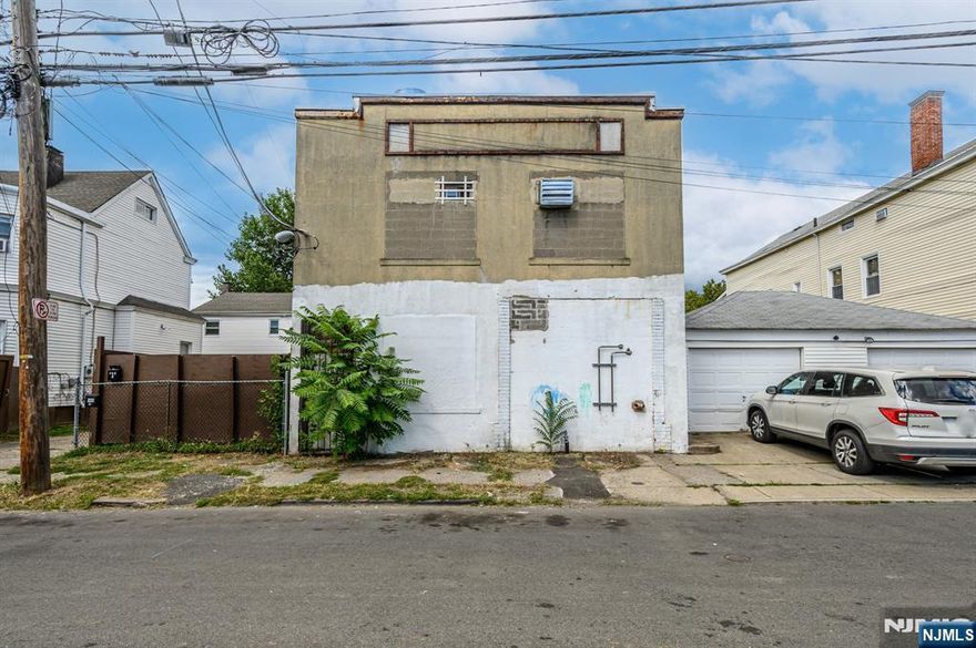 Your Next Best Investment Opportunity Awaits! Exceptional 4000 sq ft Freestanding Industrial building with 2000 sq ft lot and endless potential in thriving Paterson, ready and waiting for you! Sale of this property also includes 165 Putnam St. (B 2922 /L 21). Spanning two levels in a prime commuter location, this industrial, mix-use gem is a rarity, offering a multitude of uses with unmatched opportunity and flexibility. Prior use as a custom cabinet manufacturing facility, it offers 10 foot ceilings, 1 garage bay with potential for a 2nd, office space, 1 /2 bath, 1 full bath, and parking for 10+ vehicles. An added bonus is a vacant lot, perfect for additional parking or future development. 3 Phase power to the building. Perfectly appointed with entry across from both bustling Lyon St and Putnam St in a prime commuter location, this property is ideal for warehouse, commercial, industrial, or potential mixed-use and residential applications. It's superior location near major highways, trains, the bus line, and NYC ensures seamless connectivity. A high visibility location sure to see your business thrive. Whether you're looking to expand your current business, invest in redevelopment, or create a mix-used residential haven, this opportunity is not to be missed! Don't miss out on your chance to secure a prime piece of real estate in this bustling New Jersey market!