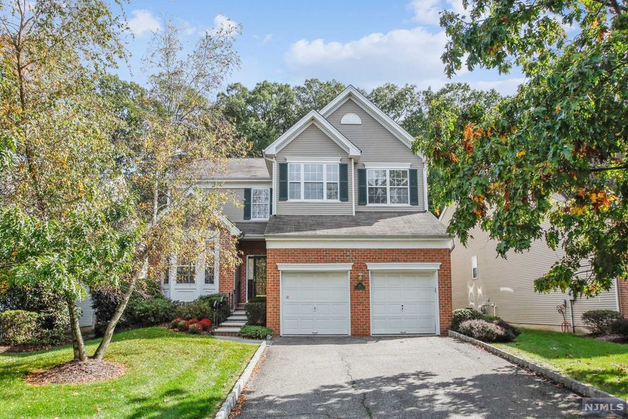 What a wonderful place to live. Reservoir Ridge is a terrific community of single family houses, grounds maintained by the Reservoir Ridge Condo Association. The community is located within the town limits of Montclair, Cedar Grove and Little Falls. Little Falls is the key with lower Passaic Co taxes. This unit boasts 10 rooms...5 beds, 2.5 baths, EIK, family room, den, LR, DR, laundry and two car garage access all on the first floor. Upstairs has 5 bedrooms and two baths. New deck looks into a park-like setting. Huge finished basement with room for pool and other game tables and much more. Custom wine closet and plenty of storage. The home has been meticulously maintained. HWF on first floor, carpet upstairs. So many windows create a bright and sunny atmosphere. Mills Reservation at RR entrance and Up Montclair center, MSU and NYC train and bus just minutes away. You are going to love living here.