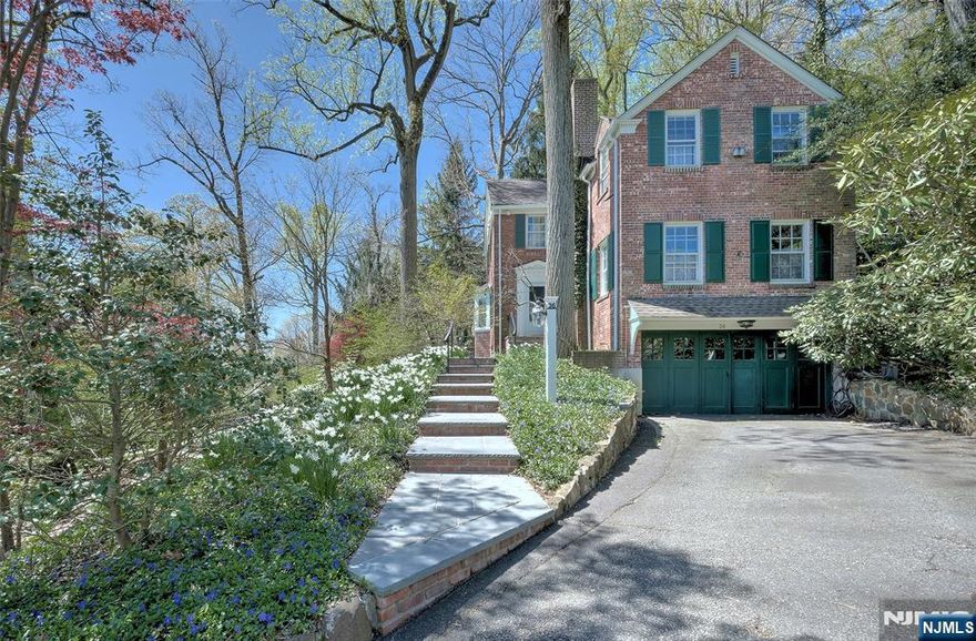 Tranquil Living Meets Everyday Convenience: Tucked beside the 151-acre Mills Reservation, this updated Montclair classic offers peace, privacy, and proximity. Enjoy a quiet, tree-lined street just minutes from the Mountain Avenue New Jersey Transit Train Station, Presby Gardens, and Mountainside Park & Pool. Inside, thoughtful updates blend modern comfort with timeless charm. INcredible opportunity to own an income producing property that has an approved ADU currently receiving rental income! (400sf rental cottage, tenant occupied.) The spacious kitchen with Cambria Quartz countertops, stainless appliances, and walk-in pantry opens to the dining room ideal for daily living and entertaining. A wood-burning fireplace adds warmth to the living room, while oversized windows in the sunroom frame rear views of the property. Step onto the deck overlooking a serene bluestone patio, natural backyard, and hot tub retreat. Upstairs, the primary suite with private bath is joined by three more bedrooms, including one perfect as a home office. In winter, enjoy glimpses of the NYC skyline through the treetops. With vibrant shops, restaurants, schools, 7 tennis courts, and trails just blocks away, this home balances convenience and calm. Move-in ready Montclair living at its best!