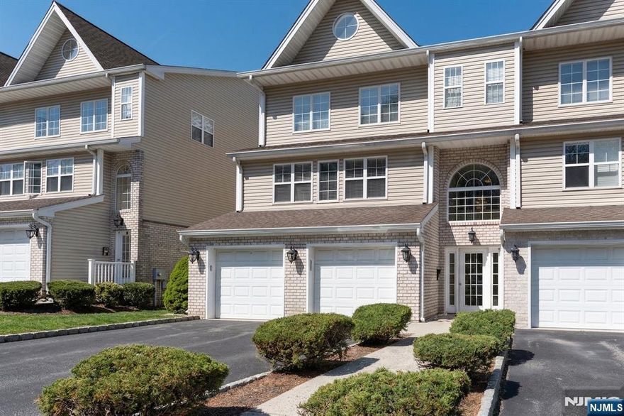 Welcome to this spacious and well-maintained townhouse in the desirable Garret Mountain Estates community! This beautifully designed 3-bedroom, 3-bathroom home offers over 2,200 sq ft of comfortable living space with a functional, open-concept layout. The main level features gleaming hardwood floors, a bright and airy living room, and a formal dining area with sliding glass doors leading to a private deck perfect for entertaining or relaxing. The modern kitchen is equipped with stainless steel appliances, ample cabinetry, and generous counter space, seamlessly flowing into the main living areas. Upstairs, you'll find generously sized bedrooms, including a large primary suite with abundant natural light and ample closet space. The home also includes multiple full bathrooms, offering convenience and flexibility. Additional highlights include a one-car garage, in-unit laundry, and central air. Enjoy outdoor living with patio/deck areas and beautifully maintained community grounds. Conveniently located near major highways, public transportation, shopping, dining, and parks, this home offers the perfect blend of suburban comfort and commuter accessibility. Don't miss this opportunity to own in one of Paterson's most sought-after townhouse communities!