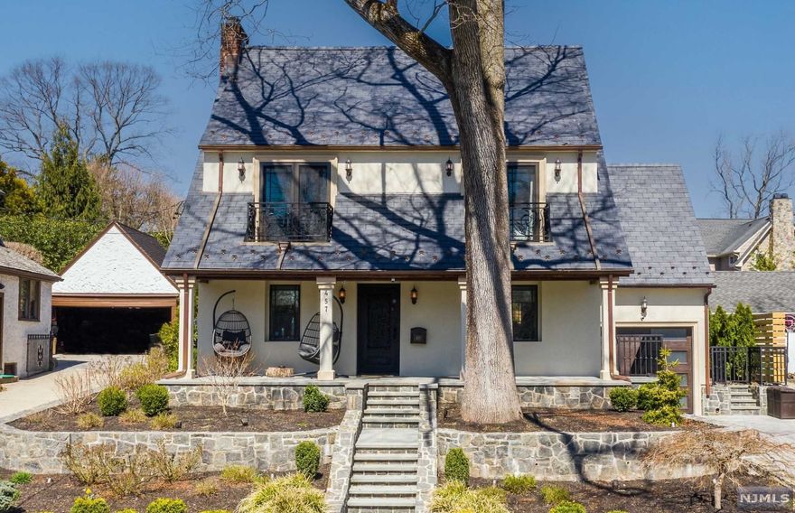 Chic modern colonial located in Ridgewood's coveted Willard area. A covered porch welcomes you to a trendy interior meticulously renovated by a contractor who owns the home as his private residence. The first level offers a true open concept with a sleek eat-in kitchen with marble counters, and high-end stainless steel appliances, a dining area, and sizable family room with fireplace. A stunning marble staircase with glass railing leads to the second level with a primary bedroom suite featuring a large walk-in closet and private balcony. A bedroom with balcony, full hallway bathroom, and third bedroom/office round out the second floor. Ideal space for bedroom and separate office or dual-office living space on the finished 3rd level. Spacious basement with a wet bar, rec room, and half bath. Backyard is perfect for entertaining with a spectacular new patio, lounge area with fire pit, and easy to maintain turf yard. Close to NYC transportation, top-ranked schools & low taxes!