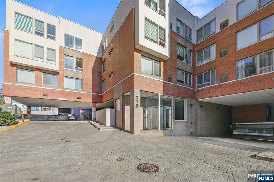 Spectacular Chic Condo with a NYC flair of sophistication! Open concept center island kitchen with stainless steel appliances, range hood, granite counter tops and glass tile backsplash. Living and dining areas offer walls of glass! Cherry floors throughout! Large bedroom with ample closet space, updated bathroom with glass tiles and jetted tub. Lots of closet space throughout. Near transportation to NYC, restaurants, shops, schools and more! You will absolutely love living here!