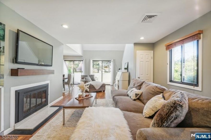 Why rent when you can own this beautifully renovated Eagle Ridge townhouse? Be welcomed by a spacious living room with a cozy wood-burning fireplace. Skylights over the dining and living area bring in gorgeous natural light and create an airy, dramatic feel. Doors open onto a private balcony with its own storage shed. An added bonus? A versatile loft space perfect for a home office or guest area. The sleek kitchen has been fully redone with crisp white cabinets, granite countertops, and stainless-steel appliances. Both bedrooms are generously sized with plenty of storage, and both bathrooms have been tastefully renovated. The main bedroom features an en suite bath, a walk-in closet, and an additional wall of closets. Laundry is conveniently located on the same floor, and there's amazing storage throughout. The heating/cooling system is newer, making this home truly move-in ready. Eagle Ridge is a gated community with incredible amenities: 24-hour security, indoor and outdoor pools (including a heated indoor pool), tennis, pickleball, a fully equipped gym and weight room, playgrounds, and a vibrant calendar of community activities. HOA covers 24-hour security, all exterior maintenance, snow removal, water, and use of the clubhouse. Location? Perfect. NYC transport is right at the gate, with shopping, dining, and an AMC theater across the street. Close to major highways and just minutes to the downtowns of Montclair and South Orange. Please note: Pics are from prior listing.