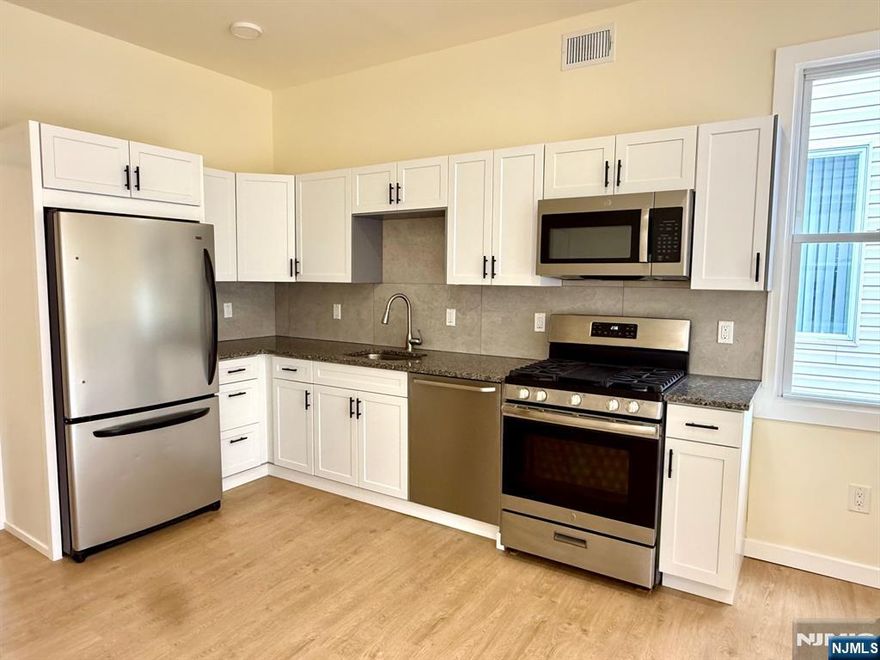 Welcome to this beautifully renovated 2 bedroom house in the heart of Secaucus, offering a modern open floor layout with a spacious living/dining area that flows seamlessly into a stylish kitchen. The kitchen is outfitted with SS appliances including a gas stove, microwave, dishwasher, and refrigerator, along with granite countertops, a tiled backsplash, and a convenient side island for casual dining. Freshly painted and updated with recessed lighting, new floors, and a brand-new bathroom featuring a stall shower, the home feels bright and contemporary. A private laundry room with washer, dryer, and sink adds everyday convenience, while a designated storage area in the basement provides extra space. Enjoy the outdoors from your own private deck, perfect for relaxing or entertaining. Small dogs are welcome, making this a pet-friendly home. With its thoughtful updates and ideal location, this residence offers both comfort and style in one. Don't wait! Set up your appointment today!