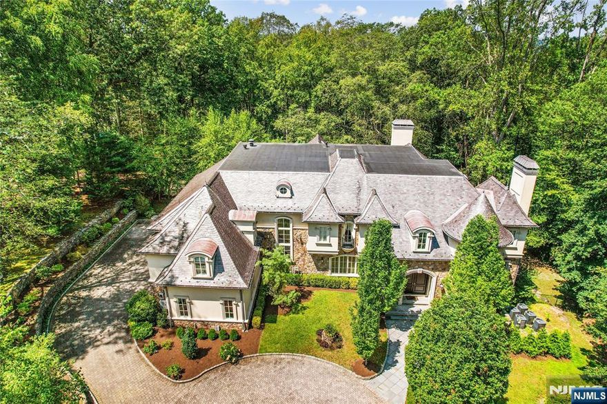 6.3 picturesque acres surround this 9000+sf European gem. Designed by Bob Zampolin & built in 2010 with extensive trim & high ceilings & elevator to 3 floors. 4-car garage, massive kitchen opening to a large great room, generously proportioned bedrooms including very large primary suite. The lower level offers large recreation room w/fireplace & bar, wine cellar, theater, indoor lap pool w/fireplace/full bath w/sauna, bedroom/bath & more! 80 KW generator, 19 zones heat. Outdoor pool, full-service cabana, outdoor walking paths around the estate. This lightly used 15-year-old estate offers privacy & tranquility.