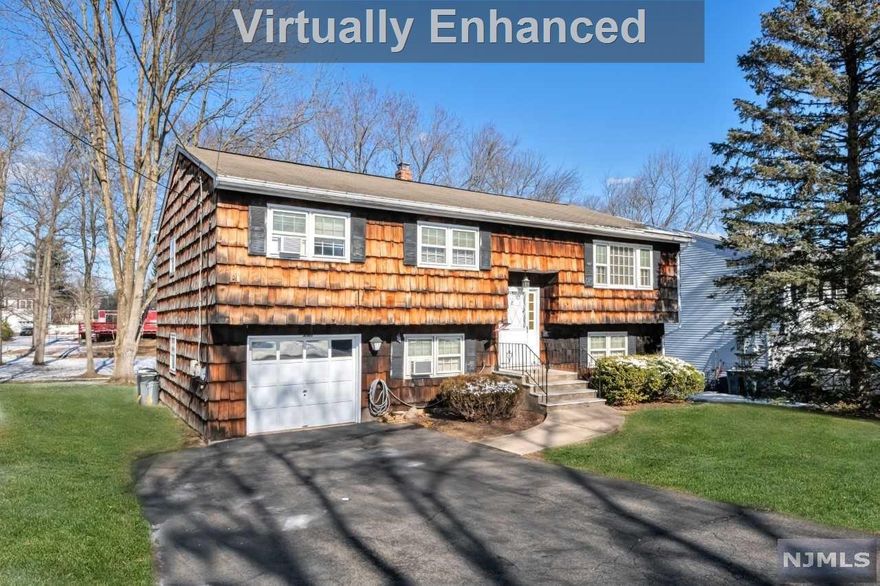 Fabulous Bi-Level located in one of Westwood's best neighborhoods...Built in 1972 offering 2600 sq. ft. set on a fabulous 75 X 166 lot. The main level features a generous sized living room which flows to the formal dining room & spacious eat-in kitchen. This level offers 3 Large bedrooms including a king size master with access to the main bath. Beautiful hardwood flooring throughout. The lower level is perfect for extended family living or for an amazing space for entertaining friends and family. This level includes a summer kitchen, family room, Dining room, 2 bedrooms, full bath, laundry room, & garage (currently being used as a bedroom) Additional features include: New Hot Water Heater 2021, Newer gas boiler, full attic access with pull down stairs...Located up the street from the Brookside Elementary School. Great downtown with many fine restaurants. Train and bus access to NYC! This home is clean as a whistle! Must see value. *Floor plan in photos*