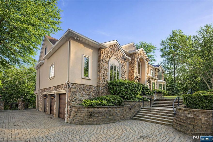 Welcome to this exceptional custom-built estate, completed in 2014 and set on over an acre of meticulously manicured private grounds in one of Montvaleâ€™s most desirable settings. A grand circular driveway and impressive three-car attached garage create a striking first impression, while the home offers over 7,600 sq ft of beautifully finished living space across all levels. This remarkable residence features 5 spacious bedrooms and 6 full bathrooms, including rare primary suites on both the main and second levels. Generous bedrooms offer walk-in closets and multiple en-suite baths. A dramatic two-story foyer and soaring great room anchor the main living spaces, complemented by a private cherry-paneled office. The expansive eat-in chefâ€™s kitchen is designed for entertaining with two oversized islands, leather-finished countertops, and seamless flow to living and dining areas, plus a dedicated second-floor laundry room. The fully finished walk-out lower level offers a massive rec room, wet bar, gym, sauna, and full bath. Outdoor living is equally impressive with sweeping views, multiple terraces and balconies, outdoor kitchen, brick oven, lounge area with outdoor TV and heaters, and fire pit. Quality construction includes 4-zone HVAC, full-house generator, radiant heated bathroom floors, smart lighting, speakers and camera systems, irrigation, and more. Exceptional opportunity in a premier Montvale location.