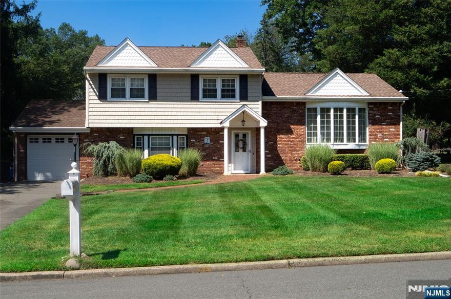 Beautifully Expanded 4-BR Home with an Open Floor Plan and gleaming hardwood floors in Hillsdale! As you enter this lovely home, you will find a large den, spacious bedroom, modern full bath, laundry and access to the backyard on the ground level. Up a few stairs is a large living room, open to the dining room and expansive great room with a vaulted ceiling and floor-to-ceiling brick fireplace. The well-maintained eat-in kitchen includes wood cabinets, a peninsula/breakfast bar and stainless appliances. Three large bedrooms and an updated full bath completes the third level. The lower level offers additional space for storage or a large recreation rooms. The lush, landscaped property offers a large backyard, complete with an expansive deck and patio-great for entertaining. An attached garage completes this home. Great location, close to schools, towns and parks!