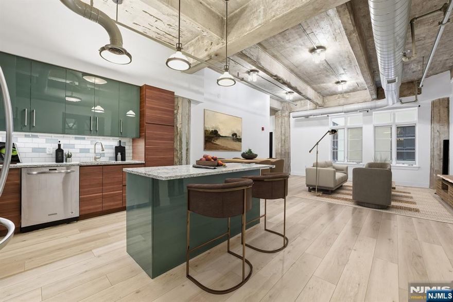 Welcome to sophisticated loft living at Cooke Lofts in the heart of downtown Jersey City. This beautifully maintained one bedroom plus den, one bath home blends authentic loft character with modern upgrades for a flexible and stylish urban lifestyle. Soaring ceilings create an expansive feel, while newly installed floors add warmth throughout. The open kitchen is designed for everyday living and entertaining, featuring ample granite counter space and generous cabinetry, flowing seamlessly into the dining and living areas. The spacious primary bedroom offers abundant closet space with custom Elfa shelving. A separate den with antique wood doors provides exceptional versatility, ideal as a home office, guest room, nursery, or creative studio - offering privacy while maintaining the homeâ€™s airy layout. The full bath features a clean, modern design. An in-unit washer and dryer, along with central air conditioning and heating, ensure year-round comfort. Residents enjoy a beautifully maintained roof deck and an unbeatable downtown location just moments from the Grove Street PATH station, offering an easy commute to Manhattan. Dining, boutique shopping, cafes, parks, and the waterfront promenade with stunning skyline views are all nearby. Perfect as a primary residence, pied-à-terre, or investment opportunity, this home captures the best of Downtown Jersey City loft living.