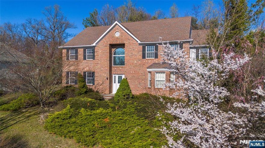 Welcome to Applewoods Estates, where timeless architecture meets modern luxury. This elegantly crafted Colonial offers close to 4,000 sq. ft. across the main floors and nearly 6,000 sq. ft. of finished living space. Featuring 4 bedrooms, 4 bathrooms, and a private home office. The home sits peacefully on a quiet Mahwah cul-de-sac and showcases breathtaking, unobstructed views of Campgaw Mountain. Located just a short walk to both the train and bus, the home offers exceptional convenience for NYC commuters - a rare advantage in such a serene setting. Inside, a sun-filled open floor plan highlights granite flooring, skylights, custom blinds, gracious ceiling heights, and a sunken family room perfect for cozy gatherings. The grand formal dining room flows seamlessly into expansive living spaces, ideal for both intimate evenings and large-scale entertaining. The Italian-inspired gourmet kitchen is a chefâ€™s delight, featuring granite countertops, premium stainless-steel appliances, a Sub-Zero refrigerator, and custom cabinetry. Upstairs, the remodeled primary suite offers a spa-like escape, while the finished basement with its private sauna creates the perfect haven for relaxation and wellness. Step outside to a brand-new oversized deck, an exceptional space for outdoor dining, gatherings, or simply savoring sunsets over the mountains.