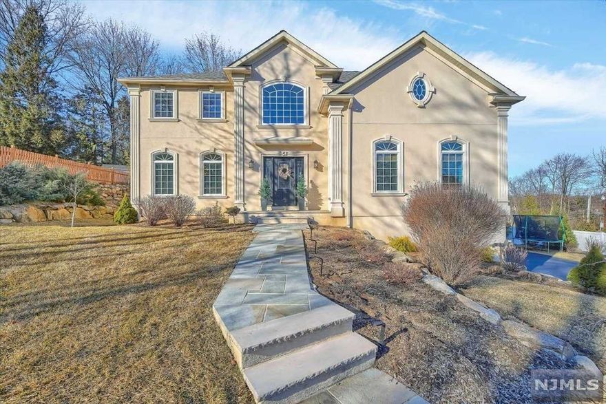 Better than new construction! No expense was spared when building this estate just 6 years ago, since it has been lovingly designed with a beautiful eye. Move right in w/ every detail done, from the landscape lights, to the window treatments & light fixtures. Upon entering you will be greeted by high ceilings & hardwood floors. Off the entryway you will find a dining room flowing into the kitchen featuring custom cabinetry, a large island & chef's appliances. The open concept floor plan flows into a great room with tons of light. This moves seamlessly to a bar area & LR. It is easy to envision friends & family gathering in this space. On this floor you will also find a tasteful powder room. Moving upstairs there is a primary retreat w/ a spa like bath, WIC & bonus space. This floor also has 3 additional BRs & a full bath. The lower level w/high ceilings is plumbed for a bath & just waiting to be finished. The manicured landscaping, a paver patio & 3car garage are the final touches