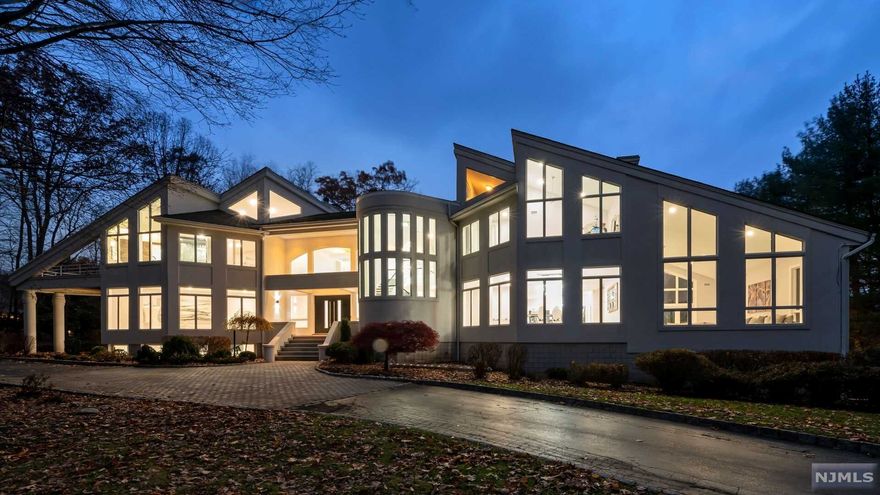 Welcome to this fully renovated incredible lakefront luxury estate nestled in the sought after Smoke Rise gated community in Kinnelon. No expense was spared on this 5 bedroom, 5 full and 1 half bath home with the highest quality finishes and an open layout throughout. First floor features a sunken great room with fireplace and floor-to-ceiling windows, family room with fireplace, bedroom suite, formal dining room, additional family/sitting room and a laundry room. The Chef's gourmet custom eat-in kitchen is complete with quartz countertops, high-end appliances, separate breakfast area and access to the large deck overlooking the private and lush backyard with Gunite pool. The second floor features a large master suite with luxurious master bath, walk-in closet, fireplace and two private terraces. Three additional bedrooms with walk-in closets and 2 full baths complete this level. The lower level is perfect for entertaining with a granite countertop wet bar, rec areas & more.