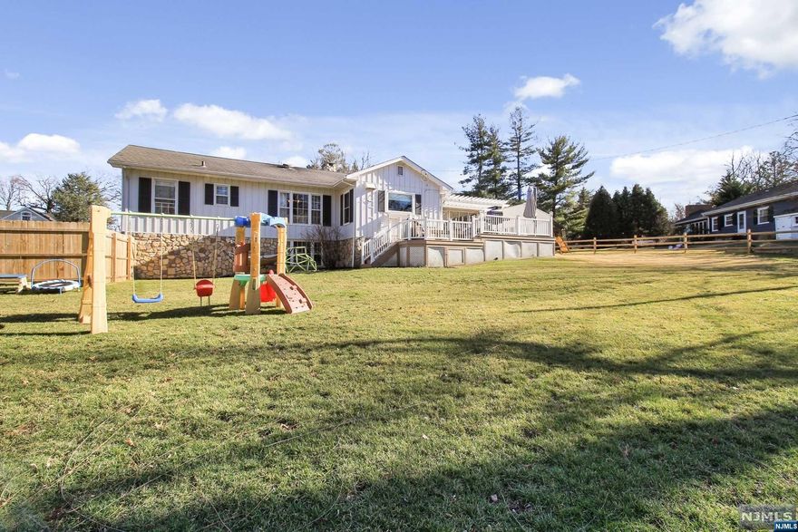 Best location in Mountainside! walk to Watchung Reservation with miles of hiking trails, Loop Park and Museum in walking distance. This raised ranch shows pride of ownership, Walk into a beautiful cozy Living room, w/wood ceilings and exposed beams, Wood floors, w/wood burning fireplace, dinning area, 3 bedrooms, 2.5 baths. The kitchen has been updated with new flooring, new back splash, SS appliances, off the kitchen is a 3 season room with new screens, and new flooring, this is perfect for entertaining on the two tier composite deck with pergola overlooking the large level yard with swing set. The full finished basement is walk out with a new spa like full bath, large rec room w/wood FP, new tile plank floors, laundry room, and office area. The main bath has also been updated. Move in ready condition, great location, near shopping, transportation, top rated schools. Mother-daughter possibility.