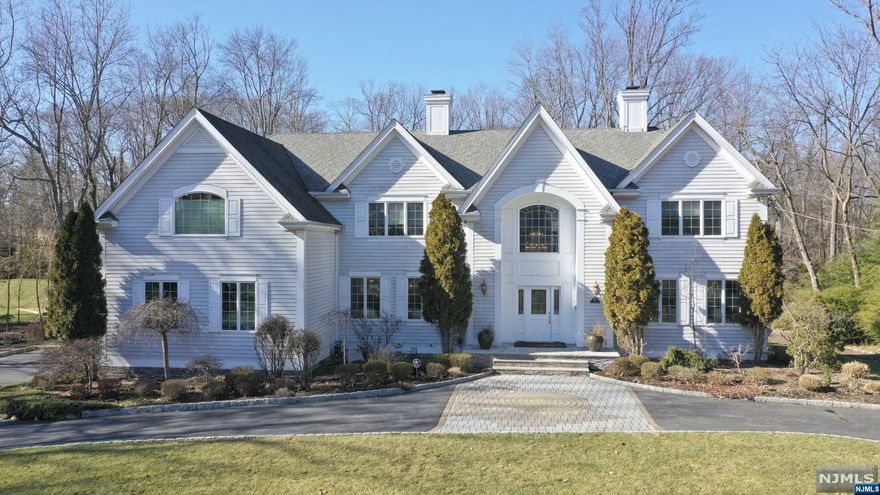 Impressive colonial manor with Hardi Plank exterior, on deep parklike setting. 2 story entry hall opening to living room, dining room and great room w/fireplace and pub area. Office/library offers ideal space for working remotely, large cherry kitchen w/breakfast area and den opening to deck with panoramic views of brook and grounds. Beautiful primary suite w/tray ceiling and sitting area, 2 WIC's and luxury bath. The lower level is walk out and offers great space for recreation and entertaining including media room, billiard area, card/game area, pub with large capacity wine refrigerator, full bath, gym and office. Two decks, 3 car garage and more! Natural gas Generac generator.