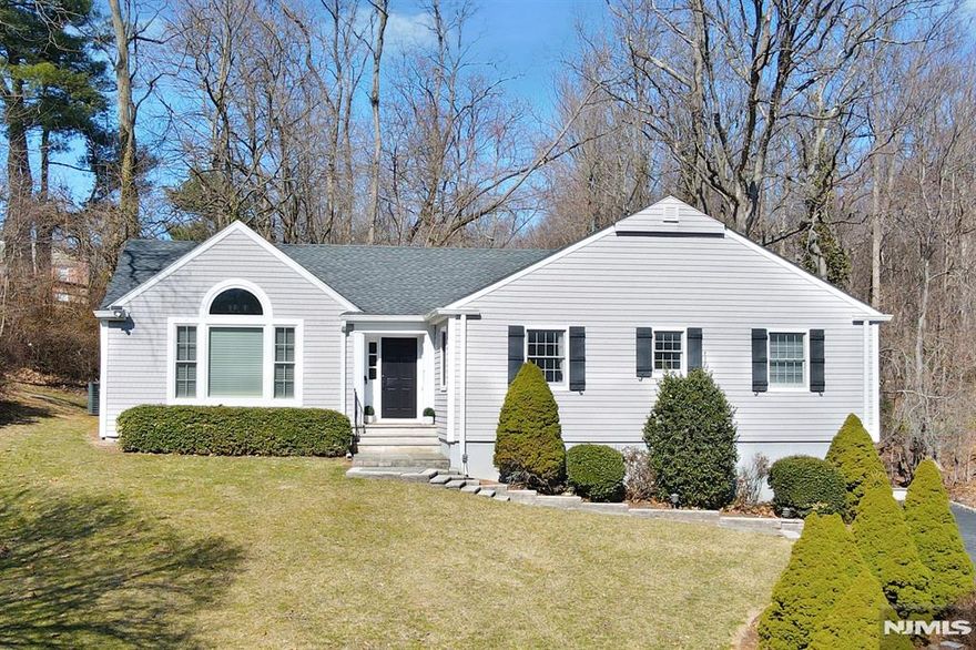 Located in the prestigious Glenwood section of Short Hills, this completely renovated (2017) 4-bedroom, 3-bathroom home offers modern living in a prime cul-de-sac . Nestled on a private, wooded lot with walking distance to Short Hills train station and the highly rated Glenwood Elementary.The home features an open-concept layout centered around a stunning 19' x 32' great room with soaring 12' ceilings and French doors that open to a spacious deck. The chef's kitchen is equipped with a large island, marble countertops, a wine fridge, and seamless flow into the great room perfect for entertaining. The luxurious primary suite boasts two walk-in closets with custom built-ins, master bath with a marble shower and double vanity. Additional highlights include a versatile family/multi-use room, a mudroom, a two-car garage and smart home technology.