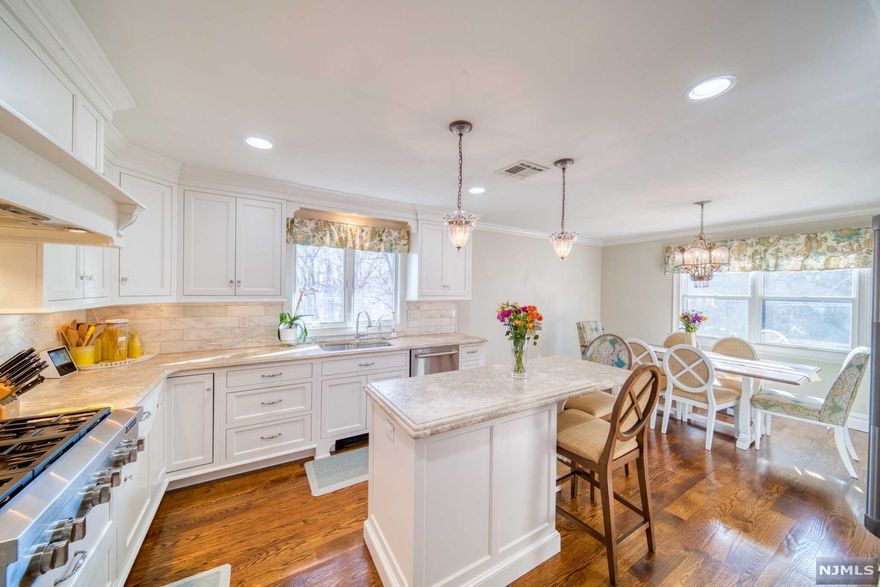 Welcome to this elegantly appointed 4 bed, 2.5 bath bi-level set on over a 1/2 acre of sprawling, level property in Old Tappan! Entry foyer features custom designed rails and spindles leading up to a light and bright living room featuring surround sound speakers! Open to the LR is the dining area and custom, Ken Bauer designed kitchen. Featuring JennAir wall oven and microwave, JennAir 6 burner range-top, JennAir refrigerator, custom designed cabinetry w/inset doors, honed limestone tops, and marble tile backsplash! Schonbek/Swarovski chandeliers throughout kitchen and dining area as well as entry foyer and main bedroom. Updated hall bath w/radiant heated floors. 2 generously sized guest bedrooms, plus a large main bedroom w/en-suite full bath and WIC! Lower level offers a 4th bedroom or flex office/gym, family room with custom built-ins, new Andersen SGD, powder rm, and laundry rm! 2 car attached gar, CAC, new furnace, paver patio, too much to list! Do not miss this one!