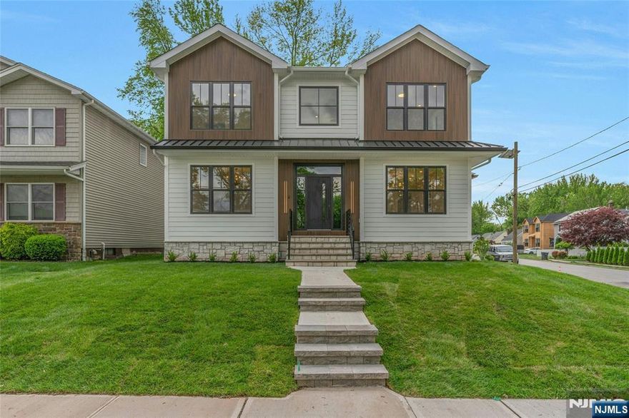 Stunning new construction in prime Bergenfield location. This very elegant and spacious center hall colonial offers a beautiful two story entry, living room, dining room, gorgeous quartz top gourmet eat in kitchen with double appliances and enlarged island with dual side cabinets adjacent to family room with gas fireplace, bedroom and full bath on first floor. Second floor features primary bedroom suite with magnificent bathroom, four additional bedrooms, two full bathrooms (one ss and one bathtub) and laundry. Basement has oversized two car garage, mudroom with custom bench and cubbies, playroom, gym, bedroom and full bath. Gorgeous 3-1/4 oak hardwood on first and second floor, closets galore all custom, nine foot ceilings on all floors, upgraded led mirrors and custom shower doors in all bathrooms, custom ceiling in dining room and primary bedroom, 22KW home back up generator, all sod landscaping, ug sprinkler system, central vac, paver patio off kitchen, 6 foot windows, 8' Anderson rear slider, 8â€™ Modern Style Metal & Textured Ardesio Nero Stone Door Entrance w/ reflective glass, door ring video camera and chime, pre wired for alarm panel at front and garage door incredible curb appeal, plus much more. Close to all. Truly a one of a kind home for a discerning buyer.